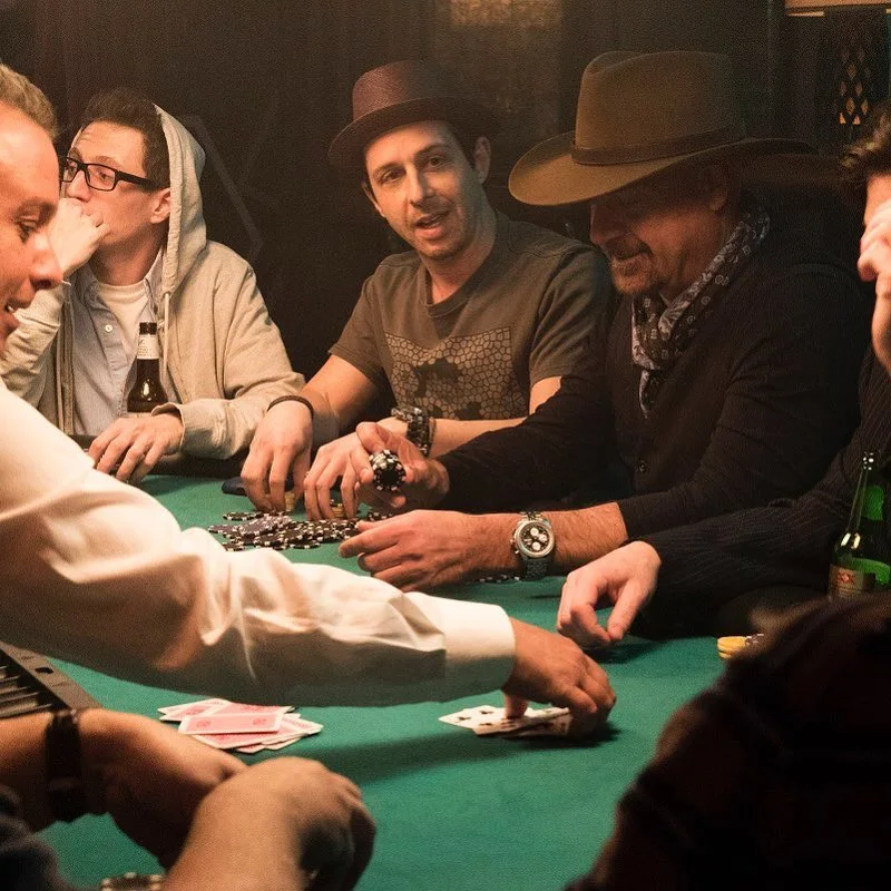 Lavish underground poker table with stacks of chips and intense players